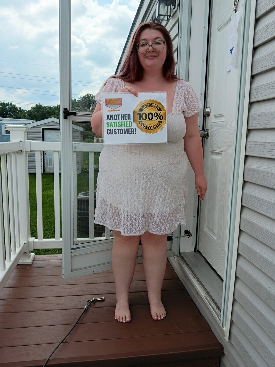 Deck Last customer standing on a finished deck with a satisfaction sign